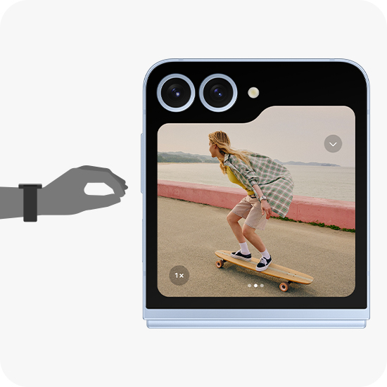 An illustrated hand with a Galaxy Watch7 is making a Double Pinch motion. Next to it is the paired Galaxy Z Flip6 with its Cover screen featuring a camera screen capturing a woman riding a skateboard.