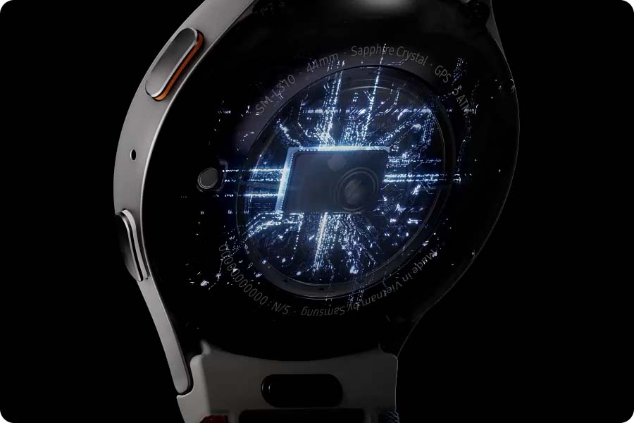 A Galaxy Watch7 seen from the back revealing its embedded processor with electric current flowing. The watch then rotates to show its screen displaying the time, a 'Energy Score' screen and a 'Daily Activity' screen, one at a time.